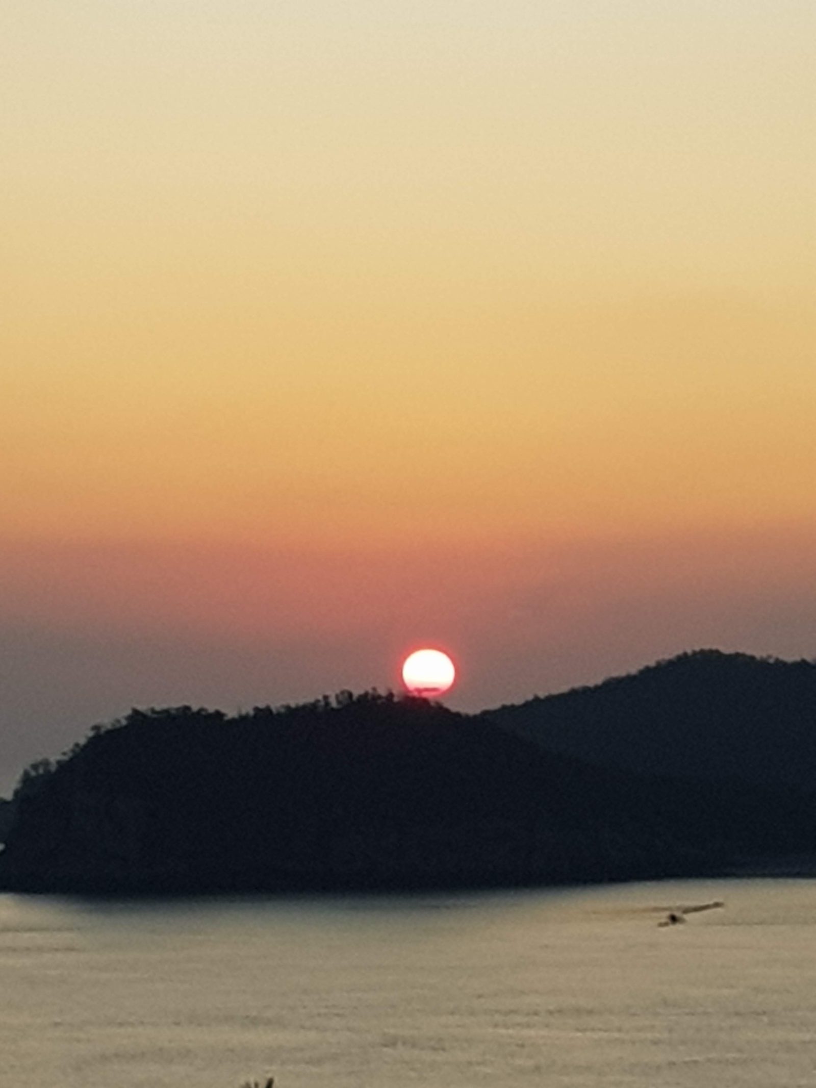 섬 능선에 절반쯤 걸친 붉은 해